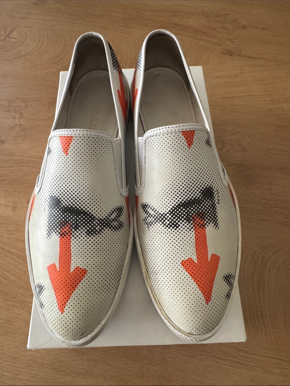 Prada White Leather Slip-On Loafers with Orange Arrow Graphic
